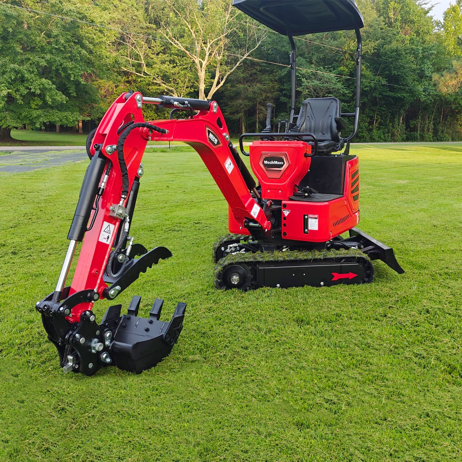 Red MechMaxx MEC10 mini compact excavator on a lawn